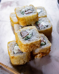 Sushi. A serving of fresh Japanese rolls on a marble board with soy sauce, wasabi and pickled ginger.