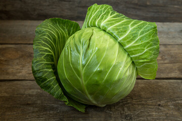 Fresh cabbage on an old wooden background