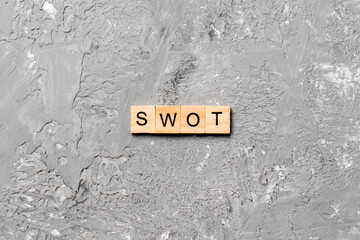 swot word written on wood block. strength weakness opportunity threats text on table, concept