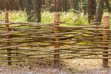 Fence made of wooden rods in the forest