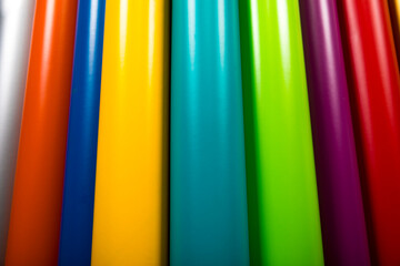 Colorful vinyl rolls on wooden background