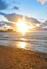Obraz na płótnie Canvas Beautiful sunset over the sea with waves on the horizon.