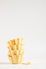 Shortcrust pastry. Cooking process of mini tartlets. Baked molds on white backgeound isolated. Violet lavander. Free copy space