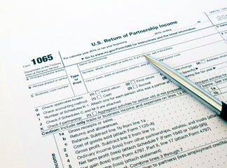 US tax form 1065 with a silver pen