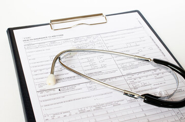 Prescription form lying on table with stethoscope. Medicine or pharmacy concept.