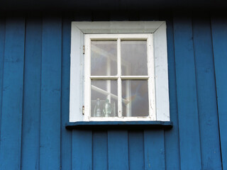 An old white window in a blue wooden wall, Trakai, Lithuania
