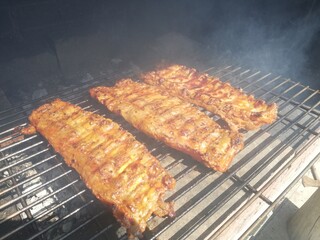 grilled meat on the grill, ribs on wood barbecue 