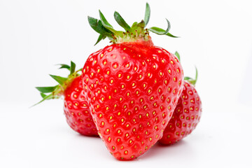 juicy and sweet red strawberries on white background in a hero pose, isolated, light  shadows....