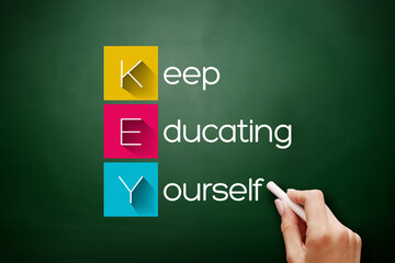 KEY - Keep Educating Yourself acronym on blackboard, education concept background