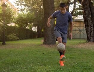 kid doing tricks with a soccer ball