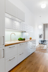 Fototapeta na wymiar White kitchen with wooden floor