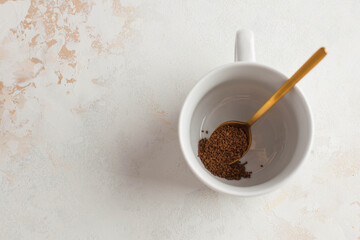 Instant coffee is poured into a white mug. July 24, instant coffee's birthday. Copy space.