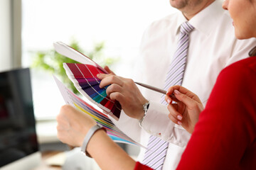 Woman with colleague holding palette