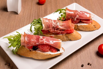 Bruschettes with jamon and grapefruit dried rye baguette