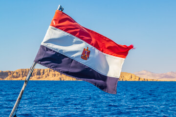 Fototapeta premium Egyptian flag on boat waving over the red sea