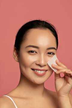 Beautiful Asian model using absorbing sheet. Fasial beauty cosmetics  product.
