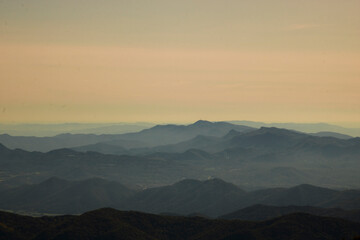 Fototapeta na wymiar Layers of mountains under a clear sky