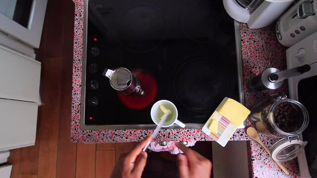 Top view person preparing bulletproof coffee with pods