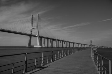 Vasco da Gama Bridge, the longest bridge in Europe, spans the Tagus River, in Lisbon, Portugal. Long exposure, black and white