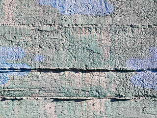 Great colorful background or texture. Abstract concrete aged with cracks, scratches and remnants of old paint in different shades. Bully smeared paint on the walls of an old building. Rough surface 