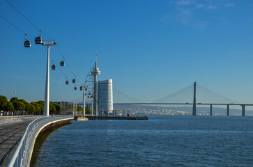 Telecabines (cable cars) at Park of Nations (Parque das Nacoes) and Vasco da Gama Bridge over the Tagus River, in Lisbon, Portugal.