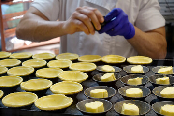 Making Portuguese Pastel de Nata Custard Tarts In A Bakery Portugal