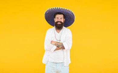 man in mexican sombrero hat. vacation concept at resort in mexico. hipster with beard looks festive in sombrero. happy brutal male celebrating fiesta. guy wear poncho. sombrero party man © be free