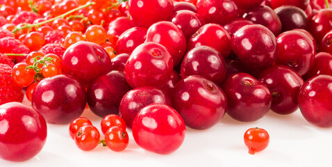Assorted berry on a white background. Cherries, raspberries, red currants.