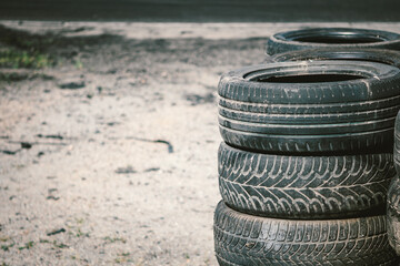 Many old used car tires stacked on top of each other on Automobile sports complex. Industrial...