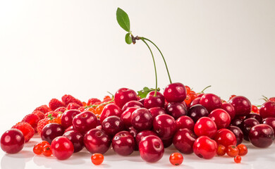 Assorted berry on a white background. Cherries, raspberries, red currants.