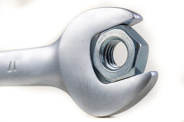 Wrench and metal nut. Accessories for mounting metal elements.
