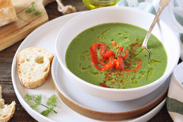 Green pea soup with spinach, olive oil, red grilled bell pepper and dill dressing