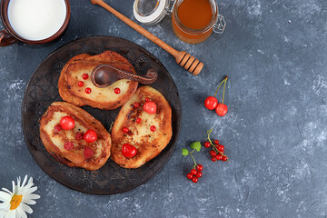 French toast with honey, milk and berries. Fried bread with milk and scrambled eggs, modern bakery concept. Healthy traditional French breakfast, selective focus, place for text