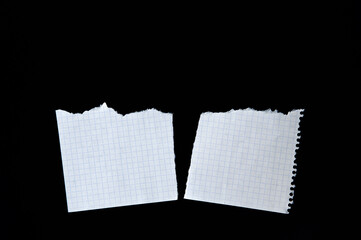 Two sheets of notebook. Torn paper on black background