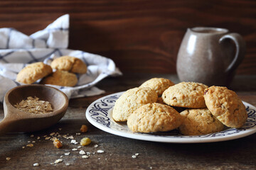 Homemade oatmeal cookies with raisins on wooden background