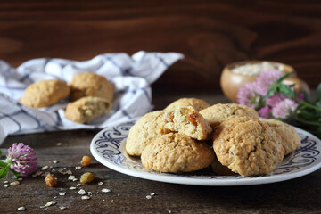 Homemade oatmeal cookies with raisins on wooden background