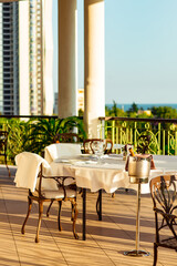 outdoor summer terrace, with cast iron.stylish furniture, in a cafe at sunset