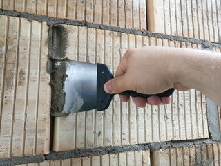 Construction worker holding taping knife tool
