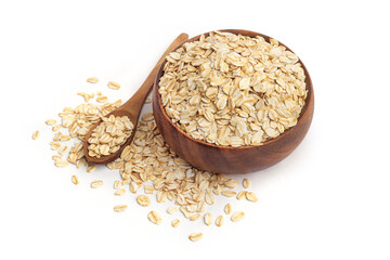 Oat flakes in wooden bowl and wooden spoon on white backround.