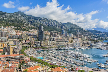 Fototapeta na wymiar Panoramic view on excellent residential buildings and marina in Monte Carlo, Monaco. Principality of Monaco is a sovereign city state, located on the French Riviera in Western Europe.