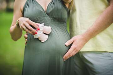 pregnant woman belly close up, with  holding hands