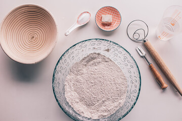 bread-making tools. Bread ingredients flour, salt, water and banneton