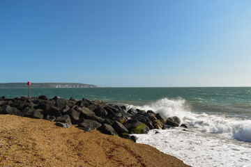 Summer Beach Waves Crashing Against Big Rocks