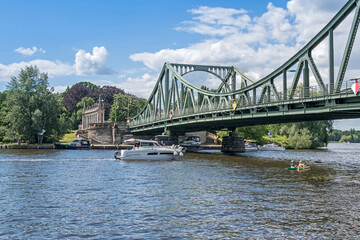 Fototapeta na wymiar Havel River with recreational boats and Glienicke Bridge in Potsdam, Germany