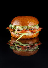 Fresh made Ciabatta Burger, with sun-dried olives, tomatoes, pesto and beef patty. Vertical photography.