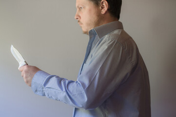 A man with a knife in a hand. Closeup.
