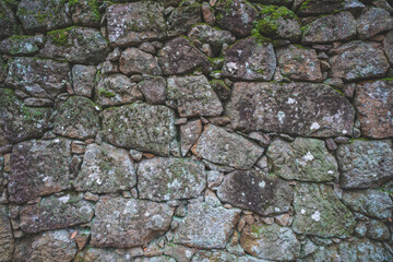 Old real stone wall surface texture. Pattern white, yellow modern style design decorative uneven cracked rocks. 