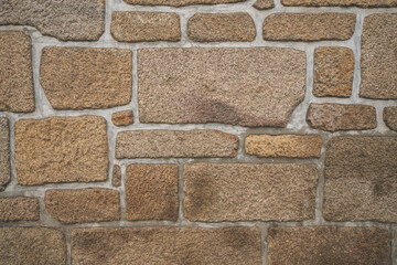 Old real stone wall surface texture. Pattern white, yellow modern style design decorative uneven cracked rocks. 