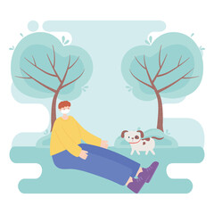 people with medical face mask, boy sitting with dog in the park, city activity during coronavirus