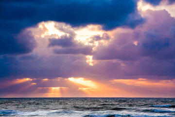 Cloudy sunset with sun rays at Seaside, Oregon